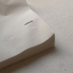 a piece of cloth with the word reflex written on it sitting on a white surface