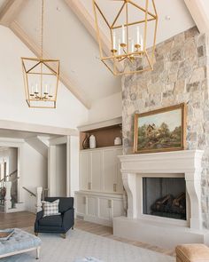 a living room filled with furniture and a fire place next to a stone wall mounted fireplace