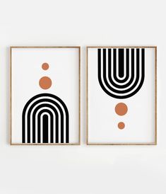 two black and white art pieces hanging on the wall next to each other, one with an orange dot