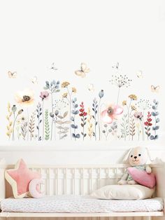 a child's room with flowers and butterflies on the wall, including a teddy bear