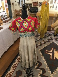 Stunningly Beautiful Antique Sioux girls beaded dress on brain tanned deer skin circa 1910 in near mint condition. Could be The Center Piece of any Beadwork Collection. ALL OF THE HISTORIC PIECES THAT I POST ON ETSY ARE THE REAL DEAL (NOT MODERN REPRODUCTIONS) AND ARE GUARANTEED TO BE AS DESCRIBED. PLEASE FEEL FREE TO CONTACT ME SHOULD YOU HAVE QUESTIONS OR WISH ADDITIONAL IMAGES. THANK YOU, BOB HICKMAN Indigenous Clothing, First Peoples, Indigenous Americans, Deer Skin, Dec 30, Sioux, Beaded Dress, Girls Dress, Traditional Dresses