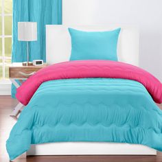 a bed with blue comforters and pillows in a room