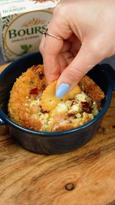 a person is dipping something into a bowl