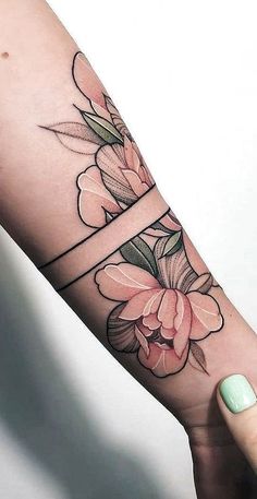 a woman's arm with flowers on it and the word love written in cursive writing