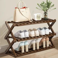 a wooden shoe rack with several pairs of shoes and a handbag on the top shelf