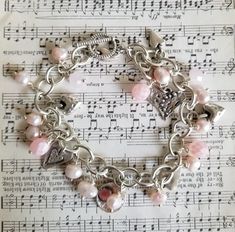 Oh my, so romantic!   This cluster charm bracelet is filled with various silver hearts, pink czech glass beads, and cultured pink freshwater pearls. It dangles gently on your wrist and it's a one of a kind bracelet fit for royalty!! Please choose your length when checking out. If you need something different please let me know.  All of my handmade treasures come in a craft brown box tied with raffia.  If you want a different color, please ask!!  Thank you for stopping by. Pink Heart Bracelet, Pink Pearl Bracelet, Valentines Bracelets, Green Charms, Cluster Bracelet, Gray Earrings, Cluster Bracelets, Bunny Earrings, Arm Bracelets