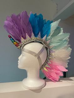 Elevate your festival look with our Enchanted Unicorn Feather Mohawk. This stunning, handmade headpiece is perfect for Burning Man, Coachella, and other vibrant festivals. Crafted with luxurious feathers and a unique unicorn-inspired design, this mohawk is a true statement piece. Features: *Unique Unicorn Design: Inspired by the magical allure of unicorns, this feather mohawk adds an ethereal and fantastical element to your festival attire. *Luxurious Feathers: High-quality feathers in vibrant colors ensure you stand out from the crowd. *Handmade Excellence: Each mohawk is meticulously handcrafted in the USA, ensuring unique artistry and top-notch quality. *Comfortable Fit: Designed for all-day wear, this headpiece features a secure and comfortable fit, perfect for dancing and celebrating. Mohawk Headpiece, Feather Mohawk, Unicorn Headpiece, Handmade Headpiece, Carnival Fantasy, Feather Hair Pieces, Dance Props, Festival Headpiece, Festival Headband