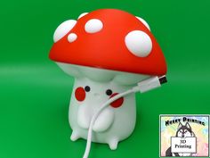 a red and white mushroom lamp on a green background