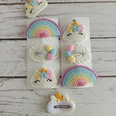 crocheted unicorns and rainbows on white boards