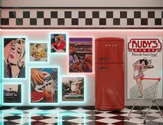 a red refrigerator sitting next to a checkered floor in front of a wall with pictures on it