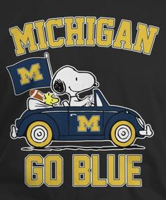 a black shirt with a snoopy driving a blue car and michigan flag on it