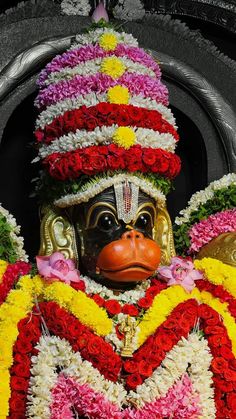 a close up of a mask with flowers on it