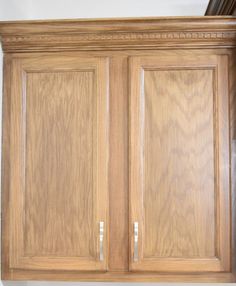 the cabinets are made of wood and have glass doors