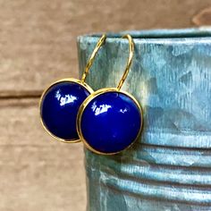 I handmade these simple & classy Lapis Lazuli Gemstone earrings with: - Natural, Semi-precious Lapis Lazuli gemstones, which measure 14mm in diameter. The gemstone cabochons are molded into gold plated cabochon base settings & gold Lever-back earring fasteners --All materials used are hypoallergenic and lead & nickel free The package contains each pair of earrings on a black earring display card, then placed in a small chiffon drawstring ('Organza') pouch (great for gift-giving!) The Elegant Cabochon Adjustable Earrings, Classic Blue Round Earrings, Blue Round Stone Earrings For Gift, Classic Blue Nickel-free Earrings, Elegant Blue Circular Jewelry, Handmade Blue Jewelry With Round Stone, Minimalist Blue Earrings For Formal Occasions, Blue Round Cabochon Jewelry, Classic Blue Hypoallergenic Jewelry