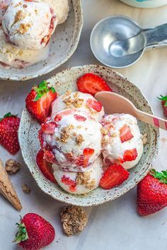 two bowls filled with ice cream and strawberries