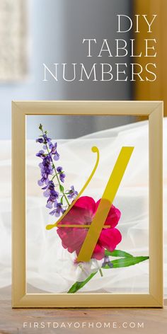 Framed table number with pressed flower details. Text overlay reads "DIY Table Numbers". Unique Wedding Table Numbers, Diy Wedding Table Numbers, Wedding Flower Table, Unique Table Numbers Wedding, Flower Table Numbers, Table Numbers Wedding Diy, Wedding Table Number Holders, Diy Table Numbers, Flower Frames