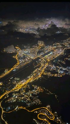 an aerial view of the city lights and roads at night from high up in the sky