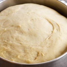 a metal pan filled with dough on top of a table