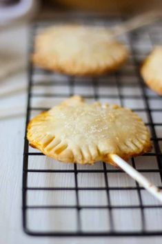 some cookies on a cooling rack with a toothpick in it