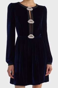 The luxurious liquid navy blue velvet Camille Mini Dress is a must for every special occasion this season. This chic mini dress features a plunge neckline held together by three lip appliques embellished with pearls and crystals. Subtle contrast banding along the neckline and button cuffs adds elegant detailing balancing the playfulness of the gently gathered mini skirt. Pair with a block heel for an elevated affair with your favorite clutch.Meaning beautiful in Sanskrit, Saloni lives up to its Camille Dress, Crystals Beads, Navy Blue Velvet, Black Lips, Denim Sweater, Denim Outerwear, Plunge Neckline, Natural Silk, Organic Fabrics