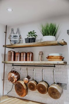 pots and pans are hanging on the wall