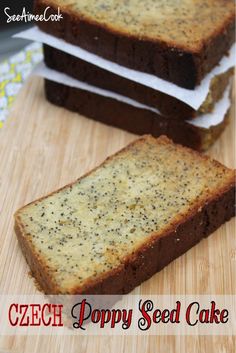 three pieces of bread sitting on top of a wooden cutting board with poppy seed cake