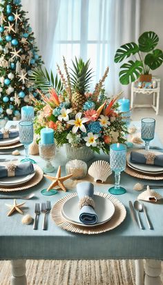 a dining table set for christmas with blue and white dishes, silverware, and decorations