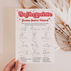 a hand holding up a paper with instructions on how to do yoga