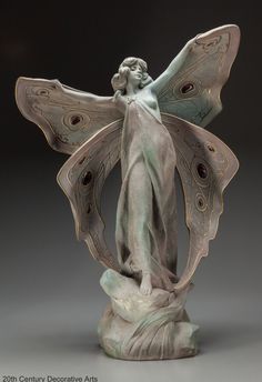 a statue of a woman holding a butterfly