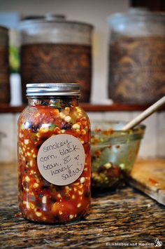 a jar filled with lots of food sitting on top of a counter