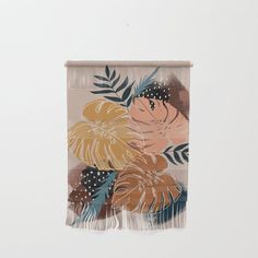 a wall hanging with flowers and leaves on it