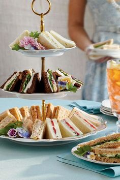 three tiered plates with sandwiches and drinks on them