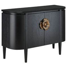 a black cabinet with a golden flower on the door