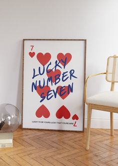 a lucky number seven poster on the floor next to a chair