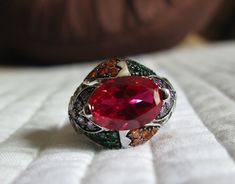 This gorgeous ring has a created red Ruby, 14mm X 10mm, as the center stone surrounded by created sapphires. The gemstones are set in 925 silver. This ring is from my "travel/cruise" collection. It is a size 8. I wear a size 7 and it fits me just fine. I no longer am traveling and so I am happily offering some of my favorites for others to enjoy. I paid twice as much over 20 years ago as I am offering it now. It looks fantastic. Enjoy! Luxury Multi-stone Round Cut Ruby Ring, Luxury Red Cabochon Ruby Ring, Luxury Silver Ruby Cabochon Ring, Luxury Multi-stone Ruby Ring In Sterling Silver, Ruby And Sapphire, Travel Cruise, Red Spinel, Silver Cocktail, Cruise Collection