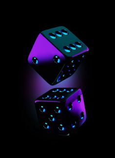 two glowing dices in the dark on a black background with blue and purple lights