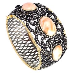 This magnificent 3 Oval shape coral with diamond leaf design around. This bangle is oval in shape and is openable on side and has safety clasp. 14kt:10.58gms Diamond:5.46cts Slv:35.61gms Coral:35.84cts Bangle With Diamonds, Rings Luxury, Leaf Jewelry, Hinged Bracelet, Diamond Bangle, Fantasy Jewelry, Sea Glass Jewelry, Gems Jewelry, Leaf Design