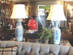 a living room filled with furniture and two lamps on top of each other's head