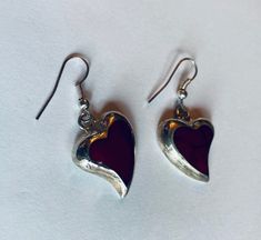 "This is a pair of heart-shaped sterling silver (.925) red dangle/drop earrings. Material(s): Sterling Silver (.925) + red stone (the photos make the heart appear black, but they are a dark red) Total weight: 6.2 grams Flaws (if any): None to mention Marking(s): \".925\" (translating to \"sterling silver\") Measurements: The drop length of these earrings is 1 and 3/8 inches. The width of these earrings is 3/4 of an inch, at their widest point. If you have any questions about this pair of earring Valentine's Day Gift Earrings With Polished Finish, Sterling Silver Heart Earrings With Polished Finish, Red Polished Earrings For Gift, Red Sterling Silver Dangle Heart Earrings, Red Sterling Silver Pierced Heart Earrings, Handmade Red Heart Earrings In Sterling Silver, Handmade Red Heart Sterling Silver Earrings, Vintage Double Heart Earrings As Gift, Vintage Double Heart Earrings For Gift