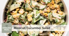 mexican cucumber salad in a white bowl with a spoon on the side and text overlay