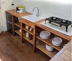 the kitchen is clean and ready to be used for cooking or baking, with dishes stacked in front of the sink