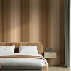 a large bed sitting next to a window in a room with wood paneling on the walls