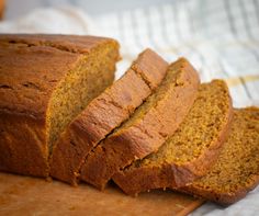 sliced loaf of pumpkin bread sitting on top of a cutting board