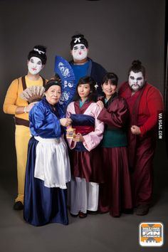 group of people dressed in costumes posing for a photo