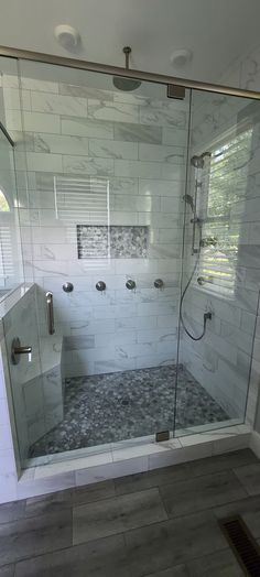 a walk in shower sitting inside of a bathroom