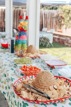 a table topped with plates and bowls filled with food