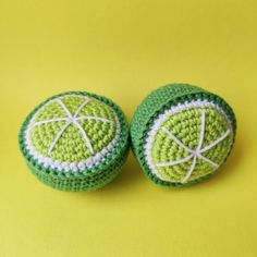 two crocheted green and white buttons on a yellow background