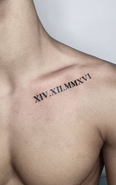 a man's chest with roman numerals tattooed on the upper half of his arm