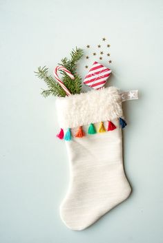 a christmas stocking with candy canes and decorations hanging from it's side