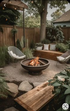 a fire pit surrounded by chairs and trees